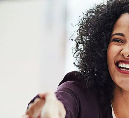 woman smiling giving a handshake