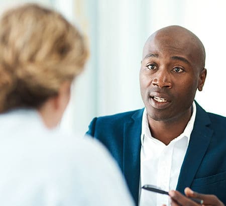 African man in suit talking