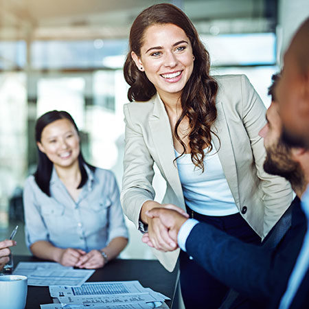 Business woman greeting a man